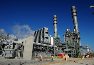 Photo by Mississippi Power TURBINE POWER: The combined cycle plant is in the foreground, with the heat recovery steam generator smoke stacks looming behind it.