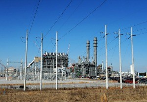 Photo by Mississippi Power TURBINE POWER: The combined cycle plant is in the foreground, with the heat recovery steam generator smoke stacks looming behind it.